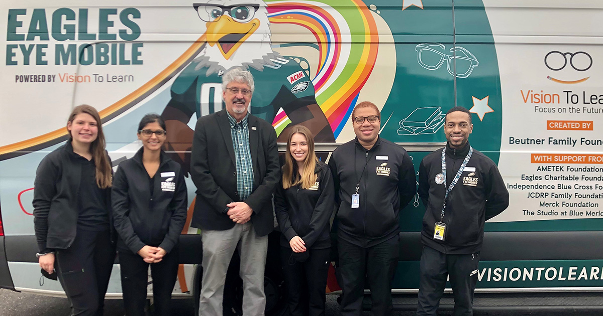 Staff from Vision to Learn pose for a quick picture with Senator Kearney in front of the Eagles Eye Mobile vehicle while visiting students at Beverly Hills Middle School in Upper Darby on Thursday.