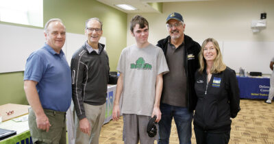 (L-R) David Cleary joins Senator John Kane, his son Michael Cleary, Senator Tim Kearney, and his wife Patricia Tuggle for a photo at the Apprenticeship Fair on Saturday.